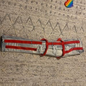 Blue jean red belt loop jeans with zippers.